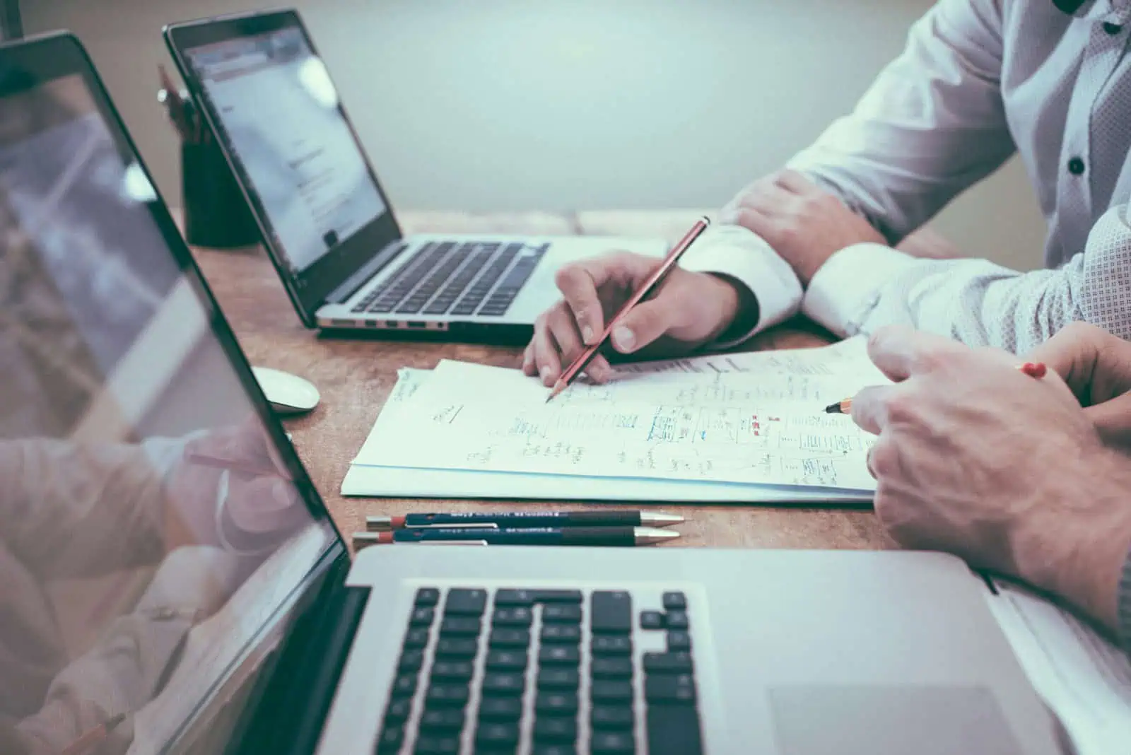 Analyse de documents d'assurance avec deux professionnels lors d'une réunion.